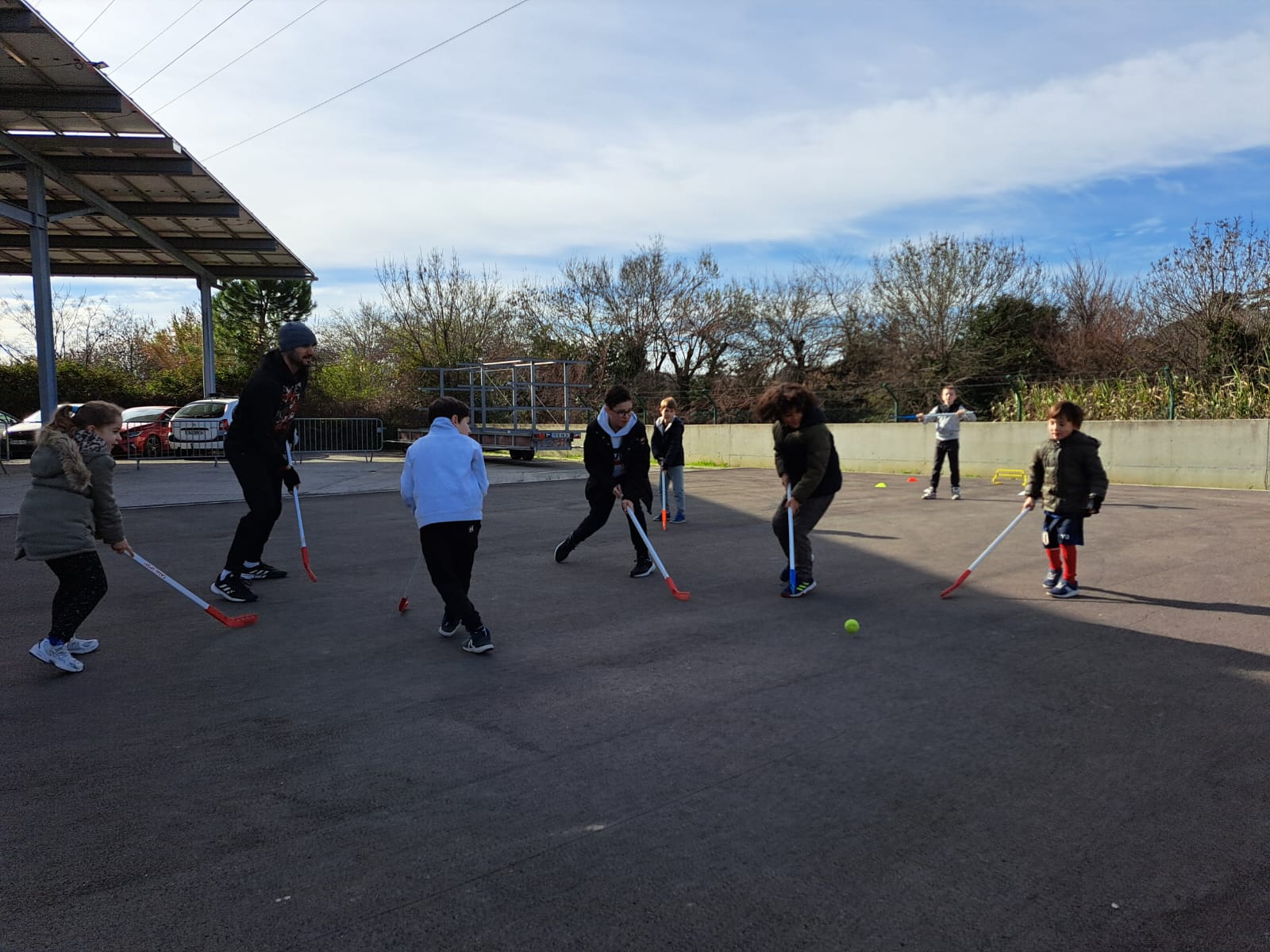 Enfants jouant au hockey en extérieur.